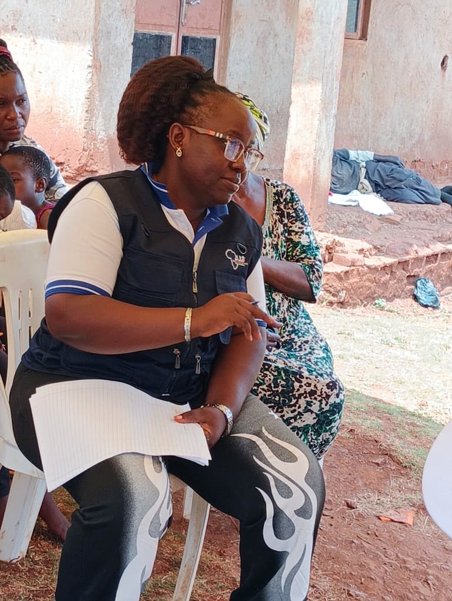 A St. Jude Africa team member speaking with families during the office gathering