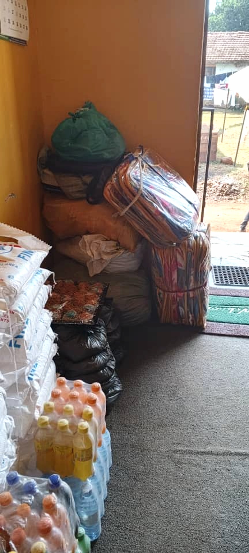 Bundled blankets and household supplies prepared inside the foundation office